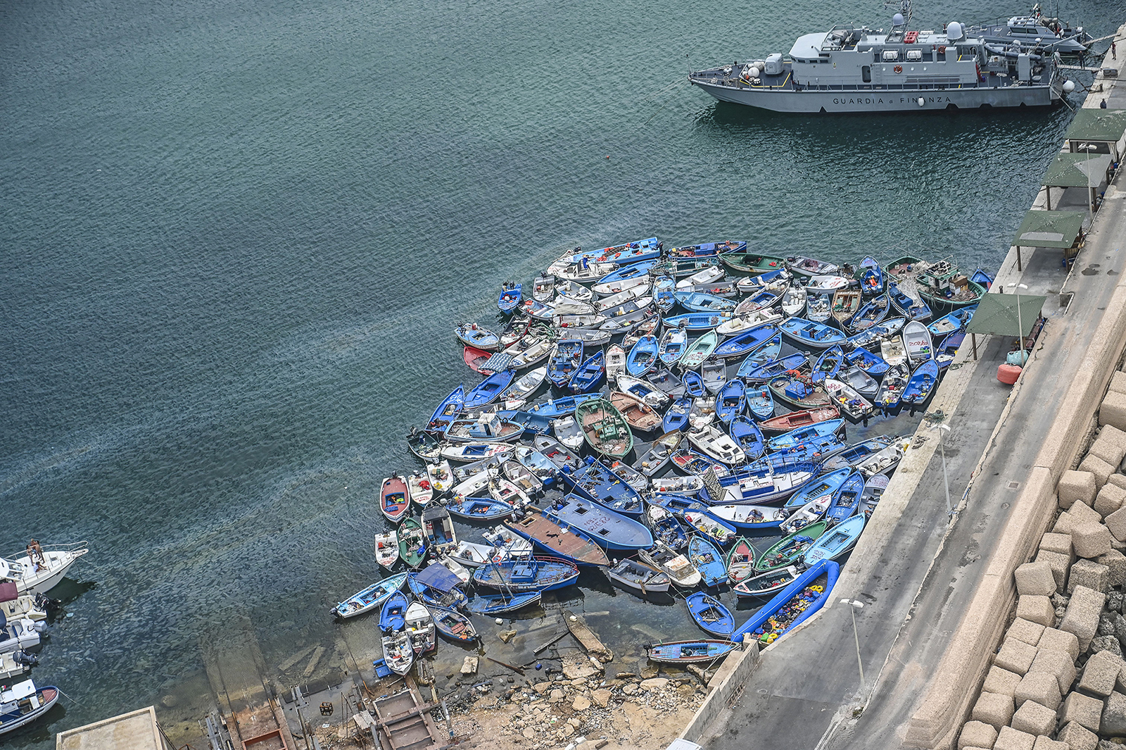 Aerial view of boats and inflatables used by migrants disembarked in recent days in Lampedusa and abandoned in the port of Lampedusa.